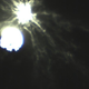 A zoomed-in view of the impact shows complex strands of ejecta stirred up the impact.